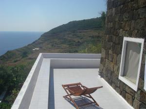 a couple of chairs sitting on top of a building at sull'arco dell'elefante in Pantelleria