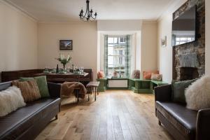 a living room with two couches and a table at Central Llanrwst apartment ~ Perfect for walkers and MTB riders in Llanrwst
