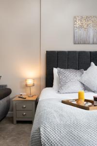 a bedroom with a bed with a tray on it at Modern studio apartment - Close to the NEC, Airport, and Solihull Town - Parking in Solihull