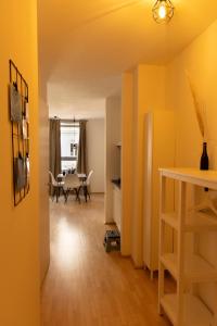 a living room with yellow walls and a table at Modern - Neu - Gemütlich - Self Checkin - zentral - Straßenbahn 38 zum Ring in Vienna