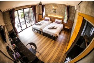 a view of a bedroom with two beds at Grandfather Khaolak Resort in Khao Lak