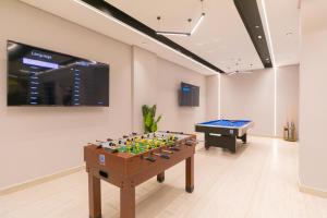 a room with a foosball table and a pool at شقة فندقية رائعة - موقع مميز حطين الرياض in Riyadh