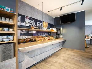 a kitchen with a counter with food on it at Ibis Budget Strasbourg Centre Gare in Strasbourg
