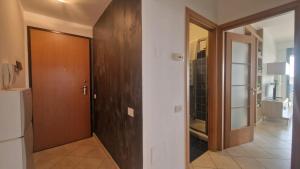 a hallway with a wooden door and a bathroom at WH - Bussana in Sanremo