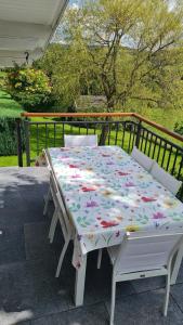 a table with a flower blanket on a patio at L'ami du circuit in Stavelot