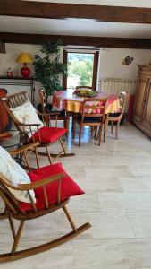 a living room with a table and chairs and a table and chairsktop at L'ami du circuit in Stavelot