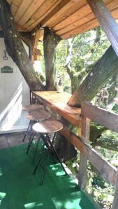 a wooden table and chairs in a tree house at Maisonnette perchée au cœur de la nature in Allonnes