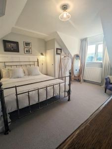 a bedroom with a bed and a large window at The Cottage @ 59 in Colmonell