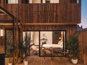 a room with a bed on a wooden deck at Marty Hotel Bordeaux - Tapestry Collection by Hilton in Bordeaux