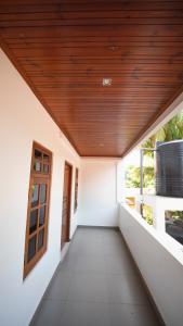 a corridor of a house with a wooden ceiling at JAMUNA VILLA in Jaffna