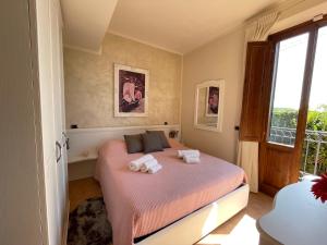 a bedroom with a bed with two towels on it at Sunset house in Castiglioncello +38 photos