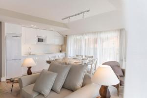 a living room with a couch and a table at Apartamentos Plaza Center in Suances