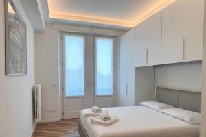 ein weißes Schlafzimmer mit 2 Handtüchern auf dem Bett in der Unterkunft Spazio Stoppani - Liberty 6 in Mailand