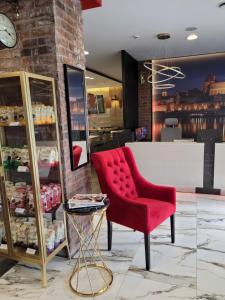 a store with a red chair and a counter at Hotel Przystanek Torun in Toruń