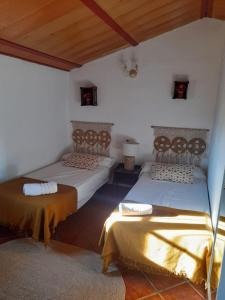 a room with two beds in a room at Casa El Castillo in Teba