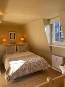 1 dormitorio con cama y ventana en Le 25, Duplex élégant au cœur du piétonnier historique, en Namur