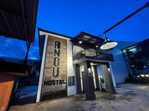 a building with a clock on the side of it at ANOU HOSTEL in Pakse