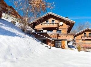 a house on top of a snow covered hill at Meribel Les Allues Ski Chalet with beautiful views in Les Allues