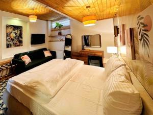 a bedroom with a large white bed and a living room at Refurbished Triplex in Taksim in Istanbul
