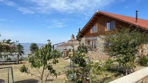 a house with a tree in front of it at BioFarm Gramsh 