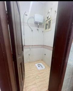 a small bathroom with a toilet in the floor at Grand M 