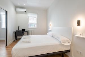 Habitación blanca con cama y escritorio en 1 bedroom 1 bathroom furnished - Salamanca - modern - MintyStay, en Madrid