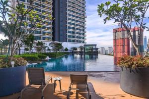 - Vistas a la piscina de un edificio con sillas en 10mins to KLCC w LRT+Mall+Netflix Muji Urban, en Kuala Lumpur
