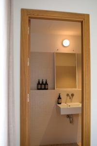 a bathroom with a sink and a mirror at Circles House in Barcelona