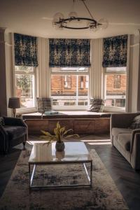 a living room with a couch and a table at The Dunes, Lytham St Annes in Lytham St Annes