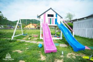 a playground with a slide in a yard at Green Garden Resort in Cicîrlău