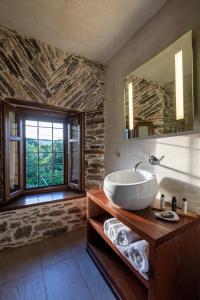 a bathroom with a sink and a large mirror at Mountain's Secret in Mouresi