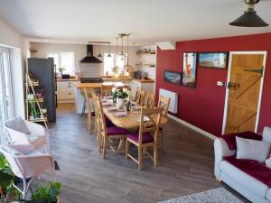 a kitchen and dining room with a table and chairs at The Sails in East Wittering