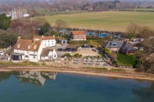 an aerial view of a house next to a body of water at The Sails in East Wittering