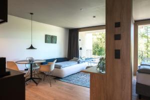 a living room with a couch and a table at Livingreen Residences in Feldkirch