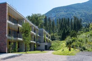 an apartment building with a mountain in the background at Livingreen Residences in Feldkirch