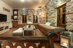 a living room with a stone wall at Mountain's Secret in Mouresi