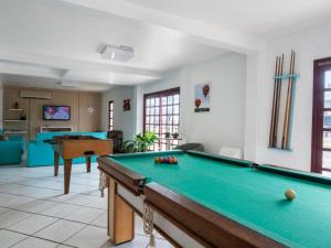 a living room with a pool table in it at Pousada Sol e Praia in Torres