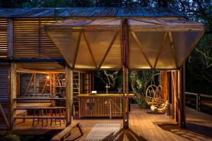 a pavilion on a deck of a house at Architectural Danish Cabin surrounded by nature in Treknow