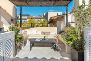 eine Terrasse mit einem Sofa und einem Tisch auf dem Balkon in der Unterkunft Designer Loft with Terrace in prime Location in Palma de Mallorca