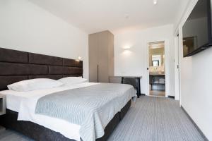 Ένα ή περισσότερα κρεβάτια σε δωμάτιο στο Hotel Alkar