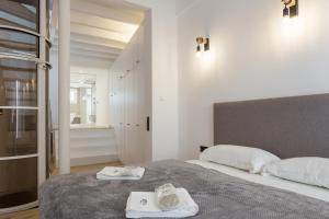 a bedroom with a bed with two towels on it at Designer Loft with Terrace in prime Location in Palma de Mallorca