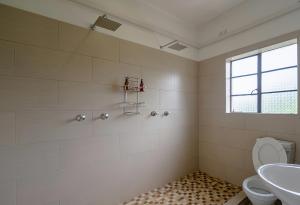 a bathroom with a toilet and a sink at Lovely deluxe with outdoor pool and gym - 2145 in Victoria Falls