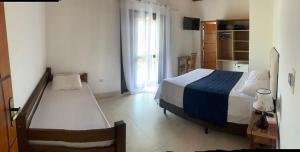 En eller flere senge i et værelse på Mar Egeu Arte & Pouso