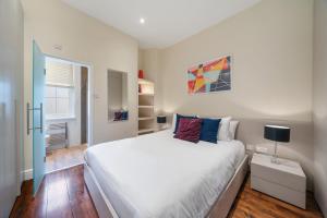 a bedroom with a large white bed and a window at Superb One Bedroom Apartment in Soho in London