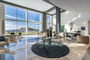 a living room with a table and chairs and windows at Barceló Aracena & Spa in Aracena