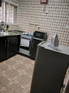 a kitchen with a stove and a counter top at Apartments Complex with Parking Ibadan Oluyole Extension - Sharp Corner in Ibadan