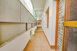 a corridor of a school with a long hallway at FabHotel Joy's Residency in Coimbatore