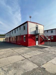 a red and white building with a staircase on it at Ubytovna SDC in Valcha