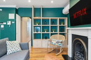 a living room with a fireplace and green walls at Fantastic One Bedroom Apartment in Soho in London
