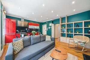 a living room with a couch and a kitchen at Fantastic One Bedroom Apartment in Soho in London